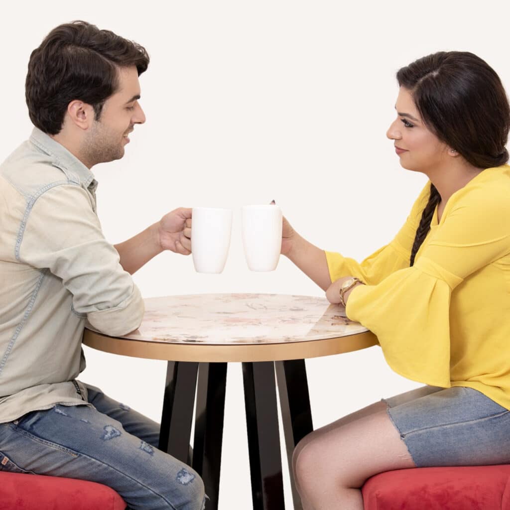 Photo of a couple having coffee together and connecting after an online relationship counseling session.