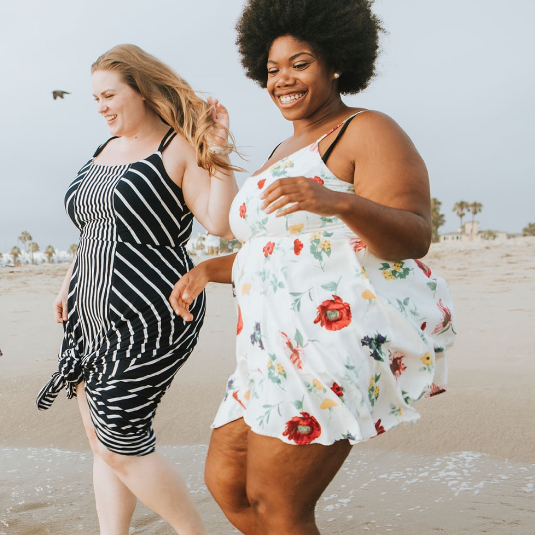 Two overweight women enjoying the beach.
