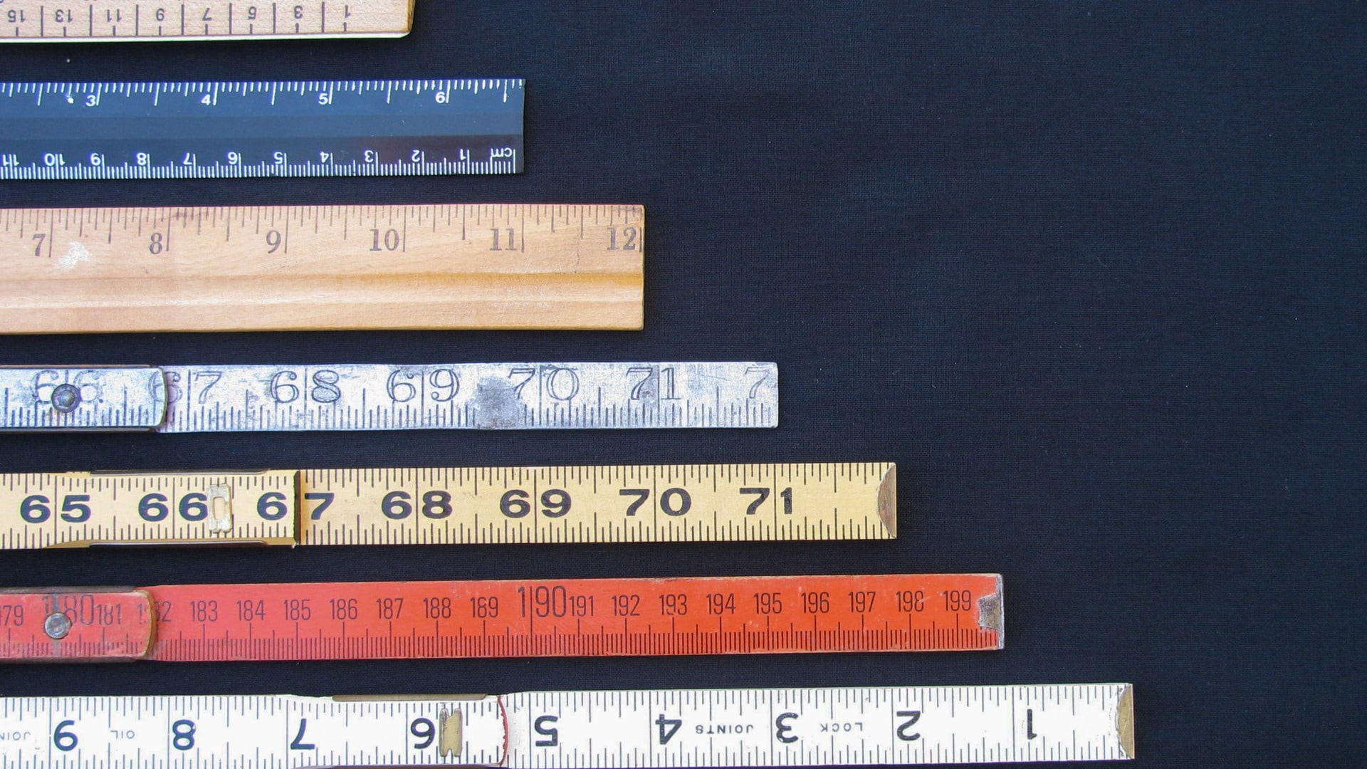 Several rulers of different colors stacked up to depict that many lifestyle changes observed are tools for tracking continuous improvement in the process of personal growth.