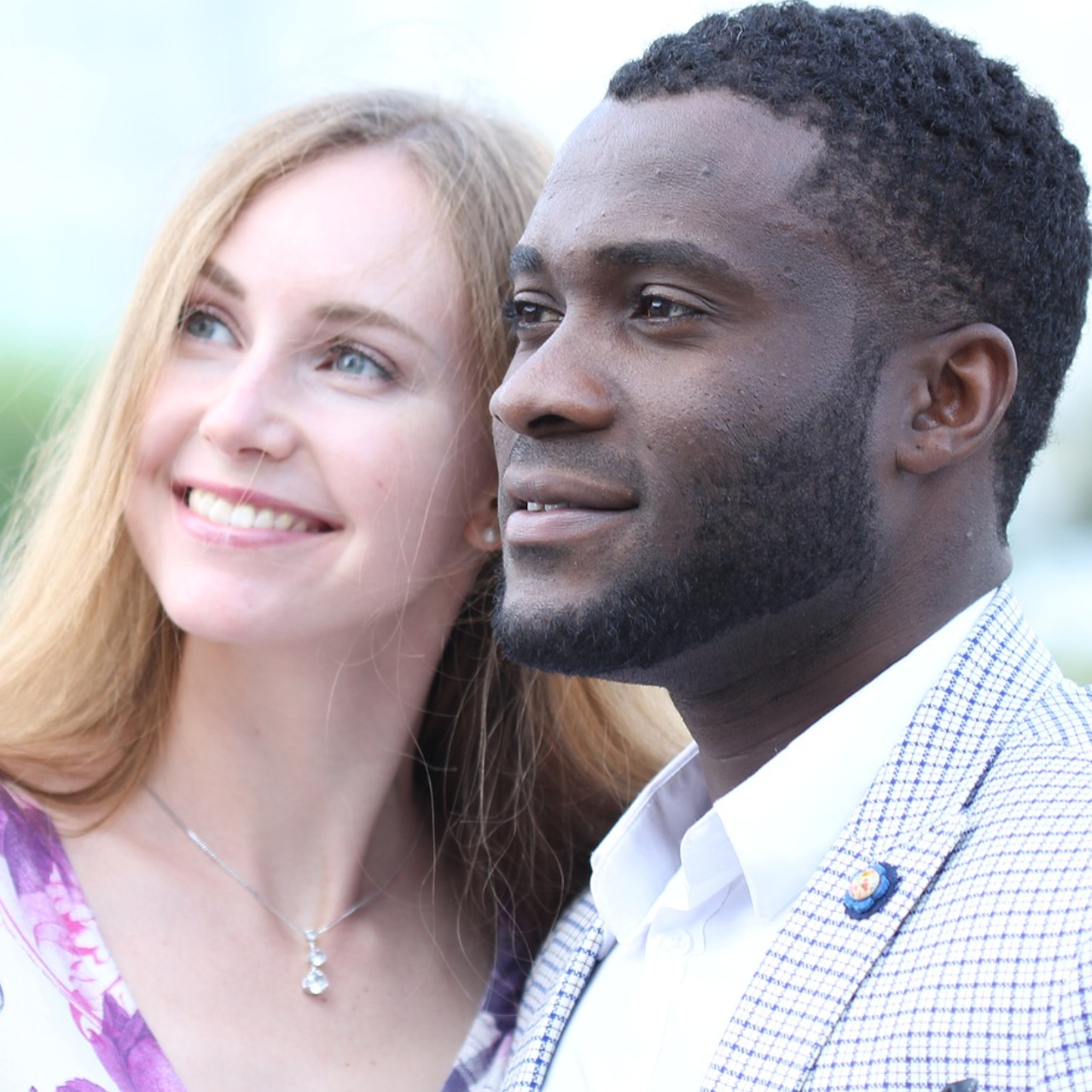 A couple smiling and looking the same direction to depict the unity created with Online Marriage Counseling and Online Couples Therapy.