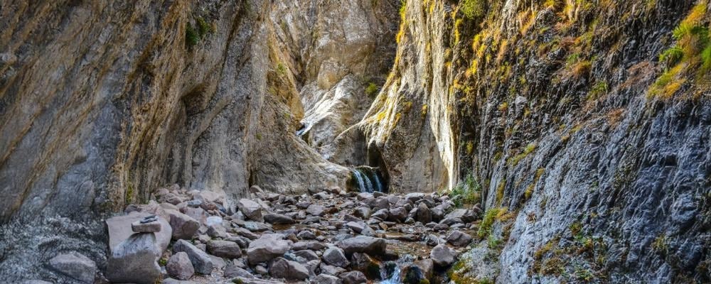 A photo of a steep cliff with rocks at the bottom covering the ground to show that rock bottom isn't necessary for recovery and that addiction isn't a choice.