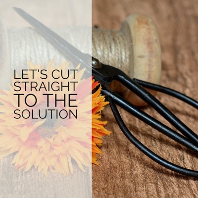 Image of Japanese scissors, twine and an orange flower sitting on a wooden table with the text "Let's cut straight to the solution" to depict solution based treatment, california and how solution focused therapy is different from traditional therapy.